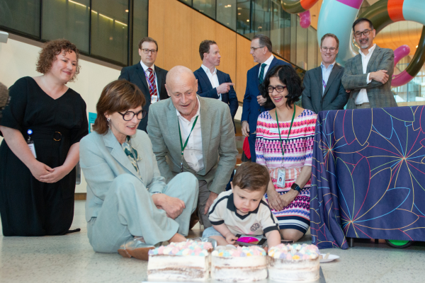 Picture of Minister Mary-Anne with baby Harlen, with others in the background